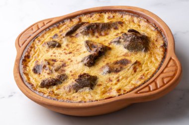 Tave kosi is a national Albanian dish of baked lamb and rice with yoghurt close-up in a pan on the table. horizontal top view from above. Turkish name; Elbasan tava clipart