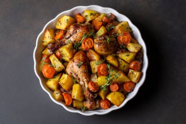 Baked chicken thighs and fried potatoes look delicious.