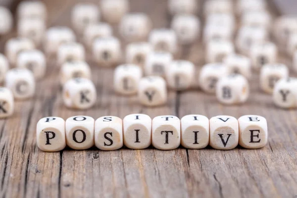 Motivational and inspirational word - POSITIVE - positive  written on wooden blocks