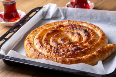 Traditional Turkish pastry with spinach. (Turkish Name: Ispanakli Kol Boregi, Bosnak boregi). Handmade pastry with spinach filling.