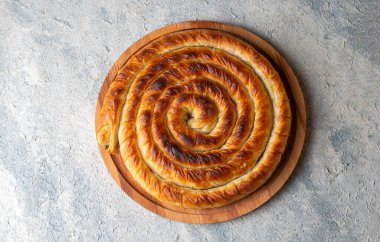Traditional Turkish pastry with spinach. (Turkish Name: Ispanakli Kol Boregi, Bosnak boregi). Handmade pastry with spinach filling.