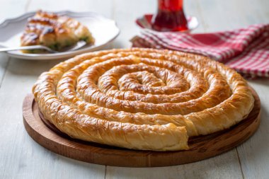 Traditional Turkish pastry with spinach. (Turkish Name: Ispanakli Kol Boregi, Bosnak boregi). Handmade pastry with spinach filling.