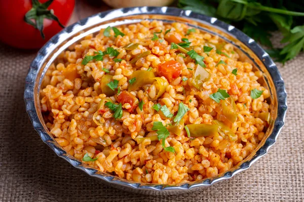 stock image Traditional turkish bulgur pilaf with tomato sause in plate (Turkish name; meyhane pilavi)