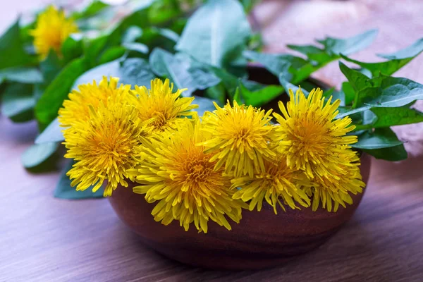 Stock image Whole dandelion plants with roots in a wicker basket