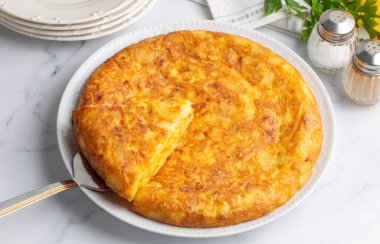 Spanish omelette with potatoes, typical spanish cuisine on gray concrete floor. Tortilla Espanola. Turkish name; Yumurtali patates