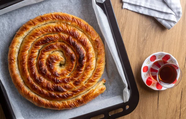 Traditional Turkish pastry with spinach. (Turkish Name: Ispanakli Kol Boregi, Bosnak boregi). Handmade pastry with spinach filling.