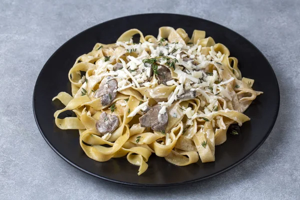 Homemade Italian fettuccine pasta (Fettuccine al Funghi Porcini) with mushroom and cream sauce. Traditional Italian cuisine.