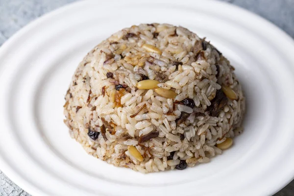 stock image Traditional delicious Turkish food; rice pilaf with pine nuts and currants (Turkish name; ic pilav or pilaf)