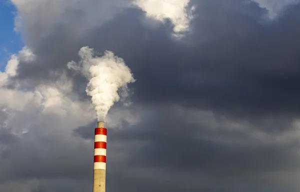 Factory chimney smoke with blue sky and clouds