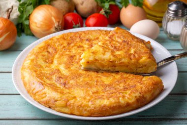 Spanish omelette with potatoes, typical spanish cuisine on gray concrete floor. Tortilla Espanola. Turkish name; Yumurtali patates