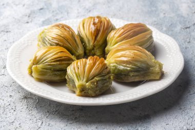 Yeşil şam fıstığı tozu ve tereyağı kremalı Türk Midye Baklava 'sı (Midye Baklava). İslami Ziyafetler Kavramı.