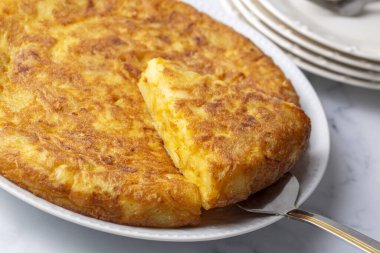 Spanish omelette with potatoes, typical spanish cuisine on gray concrete floor. Tortilla Espanola. Turkish name; Yumurtali patates
