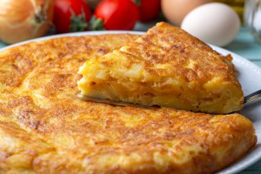 Spanish omelette with potatoes, typical spanish cuisine on gray concrete floor. Tortilla Espanola. Turkish name; Yumurtali patates