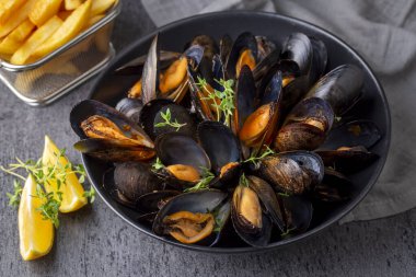Delicious seafood mussels with parsley sauce and lemon. Delicious steamed mussels