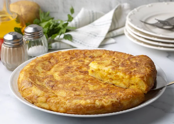 Spanish omelette with potatoes, typical spanish cuisine on gray concrete floor. Tortilla Espanola. Turkish name; Yumurtali patates