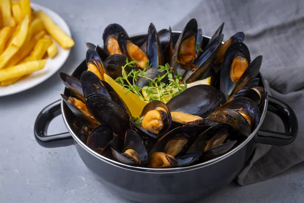 Delicious seafood mussels with parsley sauce and lemon. Delicious steamed mussels