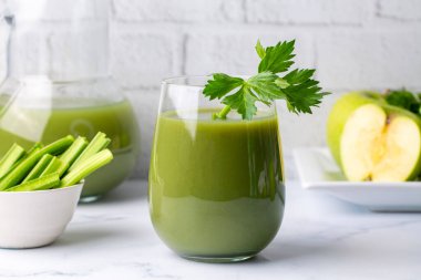 A glass of green celery juice. Celery drink prepared for healthy nutrition and detox.