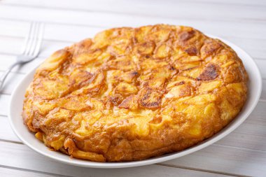 Spanish omelette with potatoes, typical spanish cuisine on gray concrete floor. Tortilla Espanola. Turkish name; Yumurtali patates
