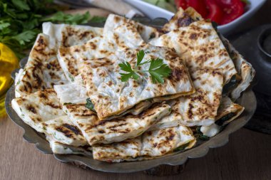 Traditional Turkish food, Turkish pancake gozleme with cheese and herb. The appetizer is Turkish pastry. There are varieties such as cheese, spinach, potato.