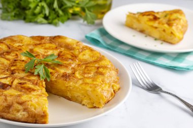Spanish omelette with potatoes, typical spanish cuisine on gray concrete floor. Tortilla Espanola. Turkish name; Yumurtali patates
