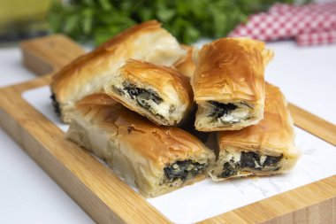 Handmade Spinach Cheese Pie - pastry, Turkish name; el acmasi borek, rulo borek. Turkish borek rolls with spinach and cheese. A traditional Turkish pastry rulo borek
