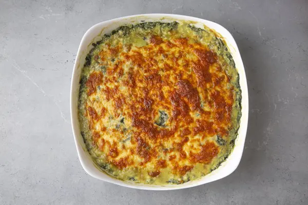 Baked Spinach with cheese delicious Italian food cuisine. Spinach gratin.