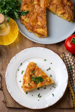 Spanish omelette with potatoes, typical spanish cuisine on gray concrete floor. Tortilla Espanola. Turkish name; Yumurtali patates