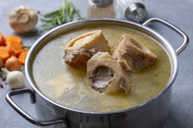Boiled bone and broth. Homemade beef bone broth is cooked in a pot on. Bones contain collagen, which provides the body with amino acids, which are the building blocks of proteins.