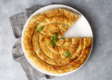 Traditional Turkish pastry with spinach. (Turkish Name: Ispanakli Kol Boregi, Bosnak boregi). Handmade pastry with spinach filling.