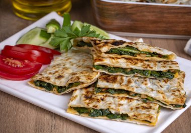 Traditional Turkish food, Turkish pancake gozleme with cheese and herb. The appetizer is Turkish pastry. There are varieties such as cheese, spinach, potato.