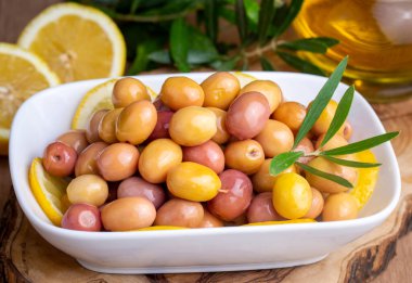 Scratched green olives. Tasty organic green olives in the plate. Olive on marble floor. Turkish name; cizik zeytin