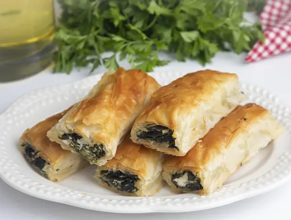 Handmade Spinach Cheese Pie - pastry, Turkish name; el acmasi borek, rulo borek. Turkish borek rolls with spinach and cheese. A traditional Turkish pastry rulo borek