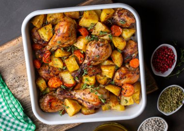 Baked chicken thighs and fried potatoes look delicious.