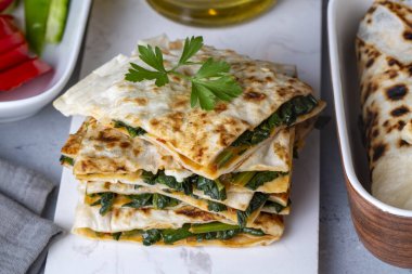 Traditional Turkish food, Turkish pancake gozleme with cheese and herb. The appetizer is Turkish pastry. There are varieties such as cheese, spinach, potato