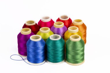 Beyaz arkaplanda renkli iplik bobinleri, dikiş, metin için yer