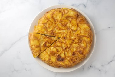Spanish omelette with potatoes, typical spanish cuisine on gray concrete floor. Tortilla Espanola. Turkish name; Yumurtali patates