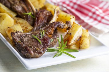 Izgara kuzu pirzola ve patates, nefis bir manzara.