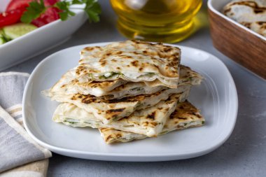 Traditional Turkish food, Turkish pancake gozleme with cheese and herb. The appetizer is Turkish pastry. There are varieties such as cheese, spinach, potato