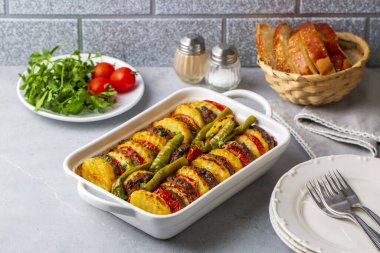 Traditional Turkish food; baked potatoes and meatballs. Turkish name; kofteli patates dizmesi, patates dizme