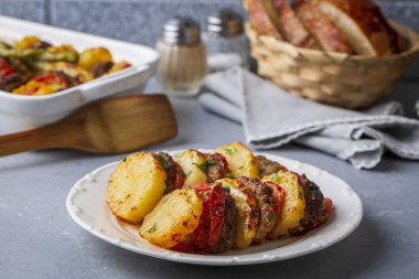 Traditional Turkish food; baked potatoes and meatballs. Turkish name; kofteli patates dizmesi, patates dizme