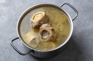 Boiled bone and broth. Homemade beef bone broth is cooked in a pot on. Bones contain collagen, which provides the body with amino acids, which are the building blocks of proteins.