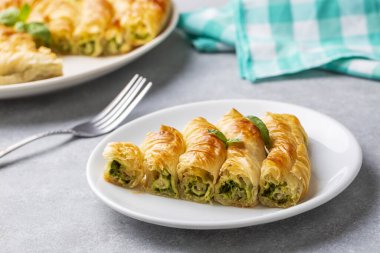 Traditional Turkish pastry with spinach. (Turkish Name: Ispanakli Kol Boregi, Bosnak boregi). Handmade pastry with spinach filling.