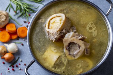 Boiled bone and broth. Homemade beef bone broth is cooked in a pot on. Bones contain collagen, which provides the body with amino acids, which are the building blocks of proteins.