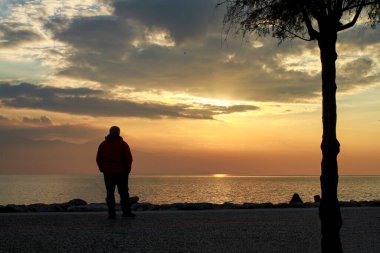 Bostanli /Izmir/Turkey, January 2, 2020, Images of people silhouette at sunset in the sea