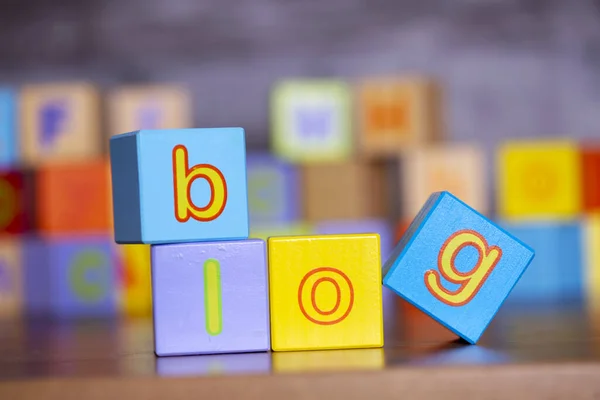 Wooden alphabet block with blog write