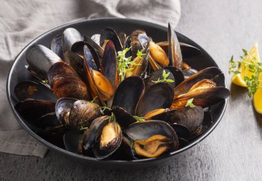 Delicious seafood mussels with parsley sauce and lemon. Delicious steamed mussels.