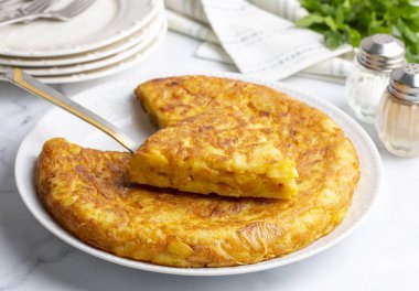 Spanish omelette with potatoes, typical spanish cuisine on gray concrete floor. Tortilla Espanola. Turkish name; Yumurtali patates