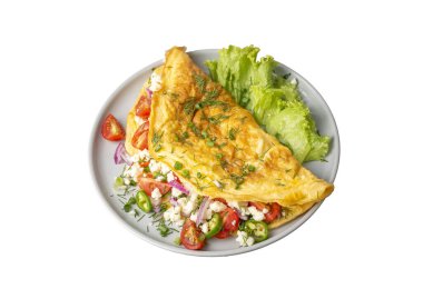 Homemade stuffed omelet on a plate. Egg omelet stuffed with fresh tomatoes, cheese and green parsley. Healthy vegetarian breakfast recipe.