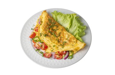 Homemade stuffed omelet on a plate. Egg omelet stuffed with fresh tomatoes, cheese and green parsley. Healthy vegetarian breakfast recipe.