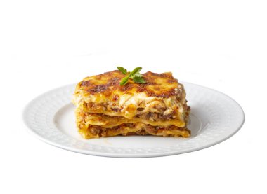 Portion of ground beef lasagna topped with melted cheese and garnished with fresh parsley served on a plate in close view for a menu